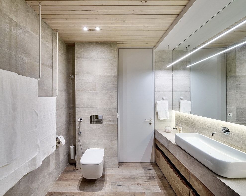 Gray ceramic tile to finish the moden bathroom with fake column for placing the toilet