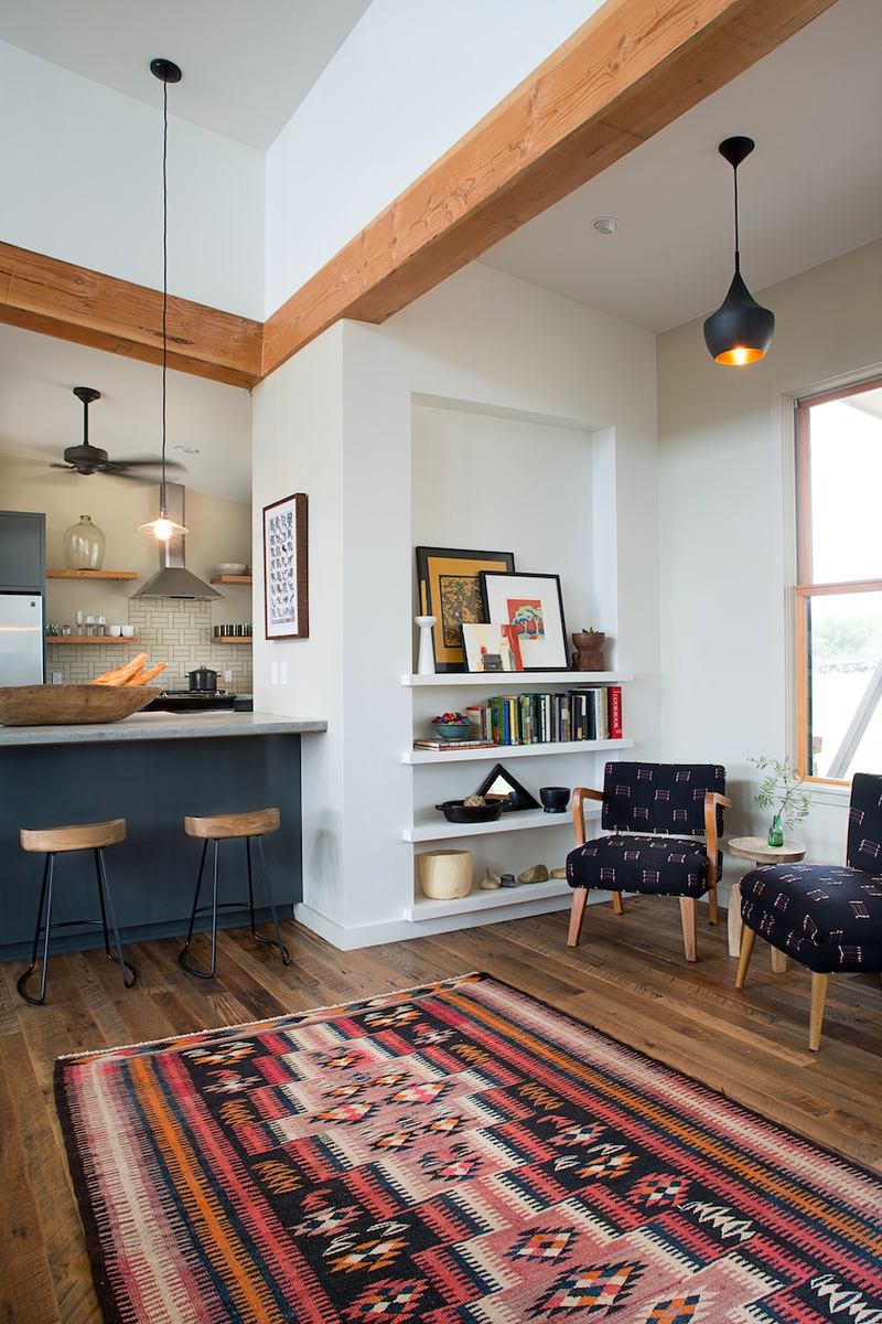 White colored open space apartment with laminate and dark furniture